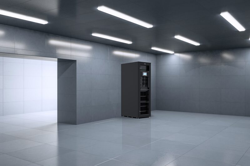A tall black Eaton xStorage Compact battery storage cabinet standing in an empty grey-tiled room