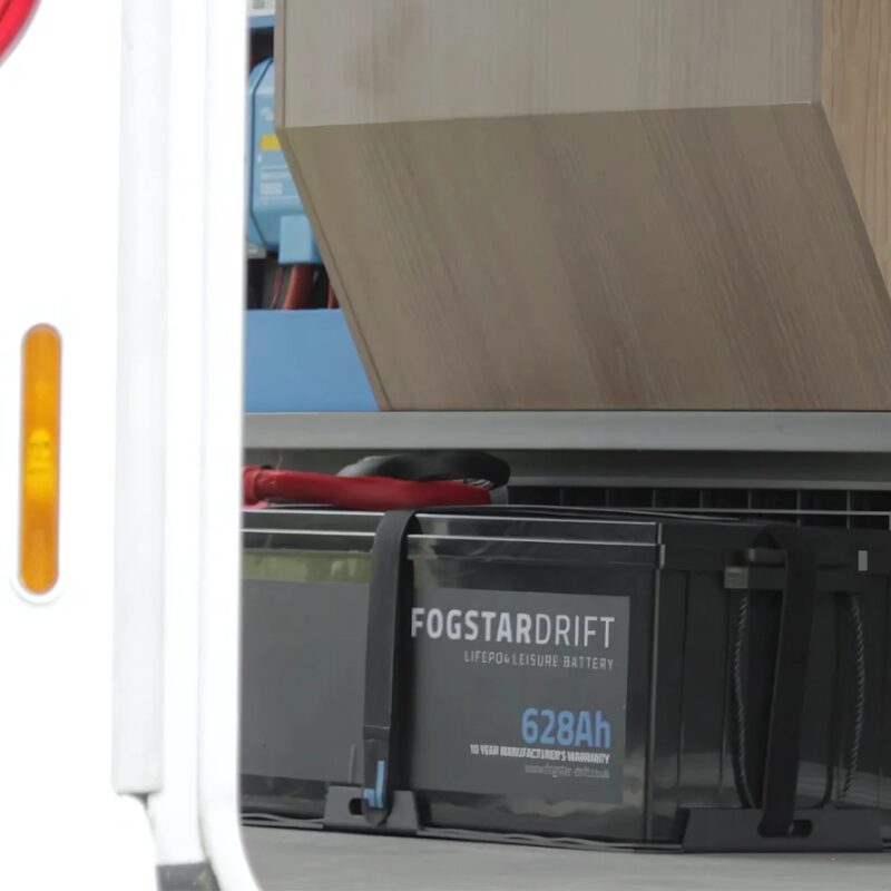 A Fogstar Drift 628Ah LiFePO4 leisure battery strapped inside a campervan