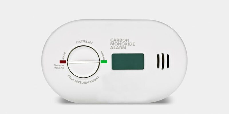 A white carbon monoxide alarm with a digital display, test/reset dial and alarm indicator lights