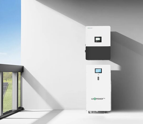 A LuxpowerTek hybrid inverter and matching home battery unit mounted on a white wall