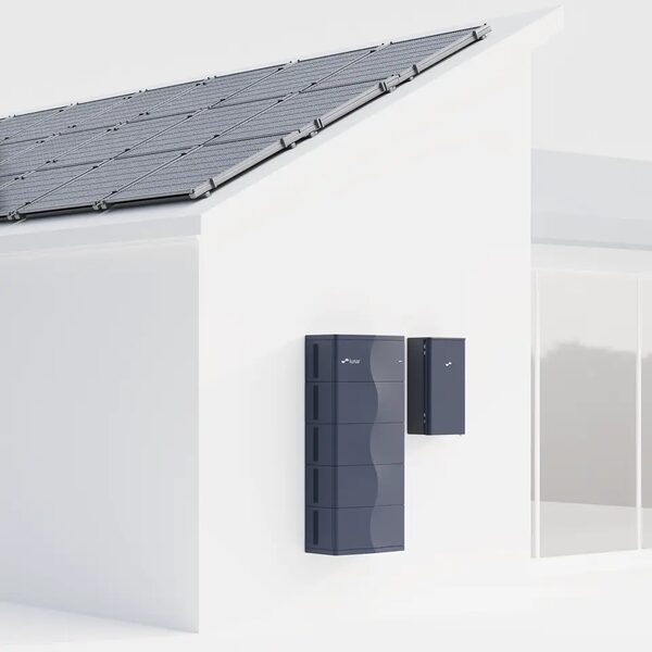 A Lunar home battery unit and inverter mounted on a white wall below a roof of solar panels