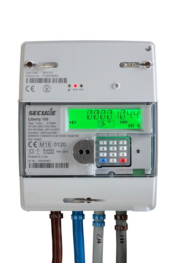A Secure Liberty 100 smart electricity meter with MID marking M18 0120, display and keypad, with cables below