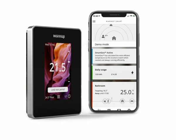A black Warmup smart thermostat next to a smartphone showing the Warmup Smart app with heating controls