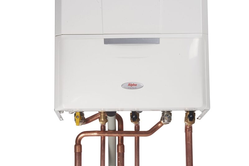 A white Alpha wall-mounted boiler with copper pipework and valves connected underneath