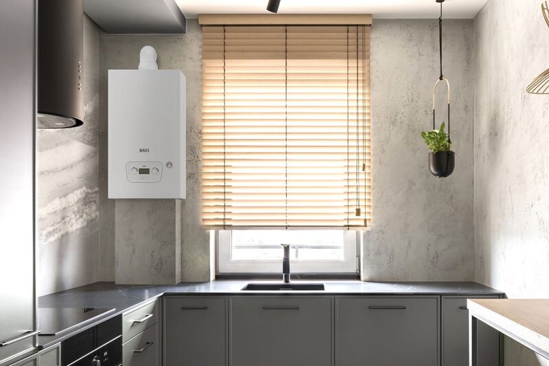 A white Baxi combi boiler mounted on a kitchen wall above a grey worktop next to a window with wooden blinds