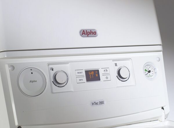 Close-up of a white Alpha InTec 28X combi boiler control panel with dials, digital display and pressure gauge