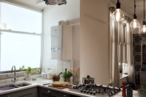 A white Ideal wall-mounted condensing boiler installed in a bright kitchen above the worktop