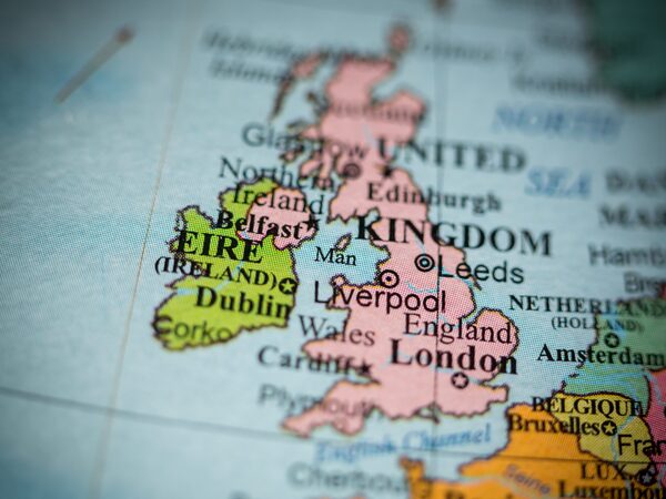 A close-up of a printed map showing the United Kingdom and Ireland with major cities labelled