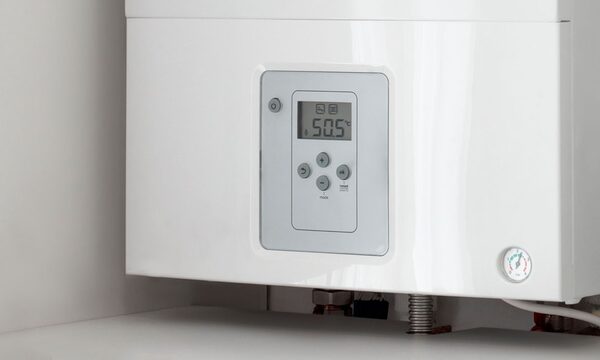 A white wall-mounted electric boiler with a digital display showing 50.5°C and a pressure gauge