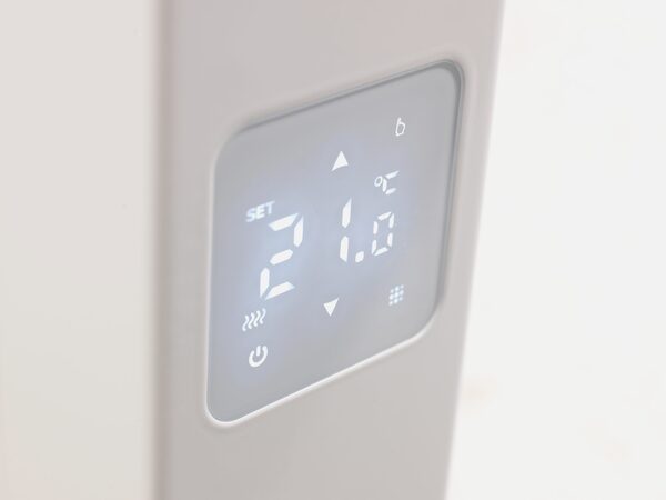 Close-up of the digital control panel on a white electric radiator set to 21.0°C