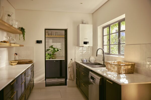 A white Vaillant wall-mounted gas boiler installed in a modern kitchen above the worktop