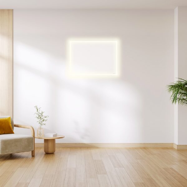 A white Herschel infrared panel heater with a glowing LED edge mounted on a white wall in a bright living room