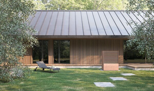 A heat pump unit installed outside a modern timber-clad house with a metal roof and lawn