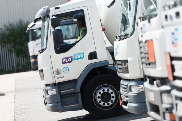 Flogas-branded LPG delivery tankers parked at a depot with a driver in the cab