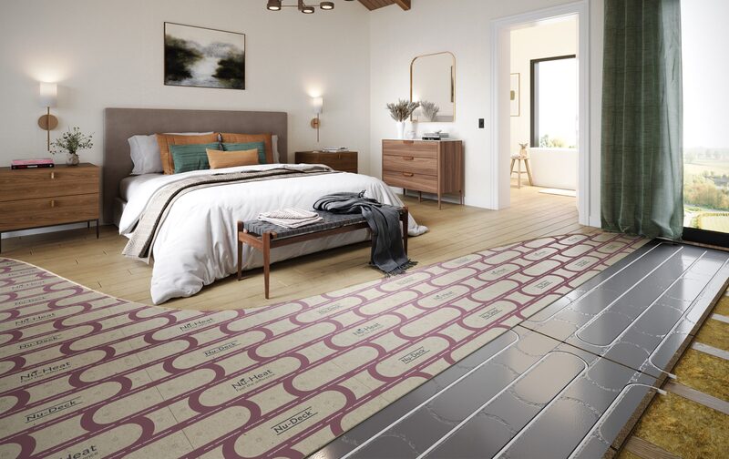 A bedroom with part of the wooden floor removed to reveal Nu-Heat Nu-Deck underfloor heating panels and pipework being installed