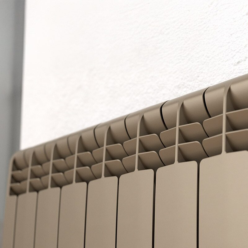 A close-up of a beige Rointe electric radiator mounted against a white wall