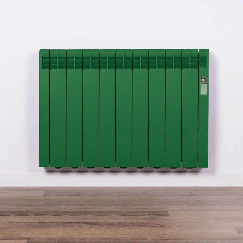 A green Rointe electric radiator mounted on a white wall above a wooden floor