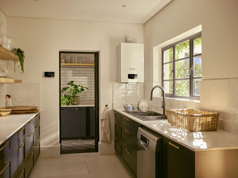 A white wall-mounted Vaillant combi boiler installed in a bright kitchen above the worktop