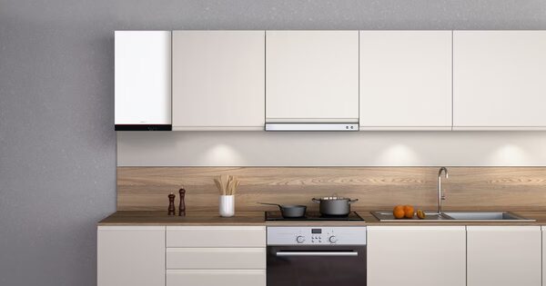 A Viessmann wall-mounted gas boiler installed in a modern kitchen above the worktop next to white cabinets