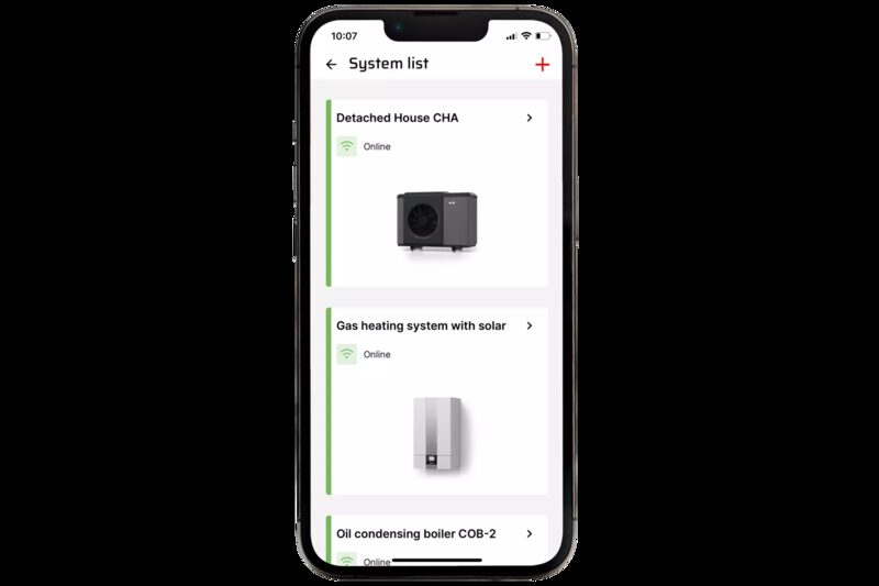 A smartphone displaying the WOLF Link app's system list screen showing connected heating systems including a heat pump, gas boiler with solar, and oil condensing boiler