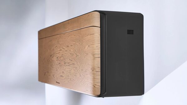 A Daikin Stylish wall-mounted air conditioner with a wood-effect front panel mounted on a white wall