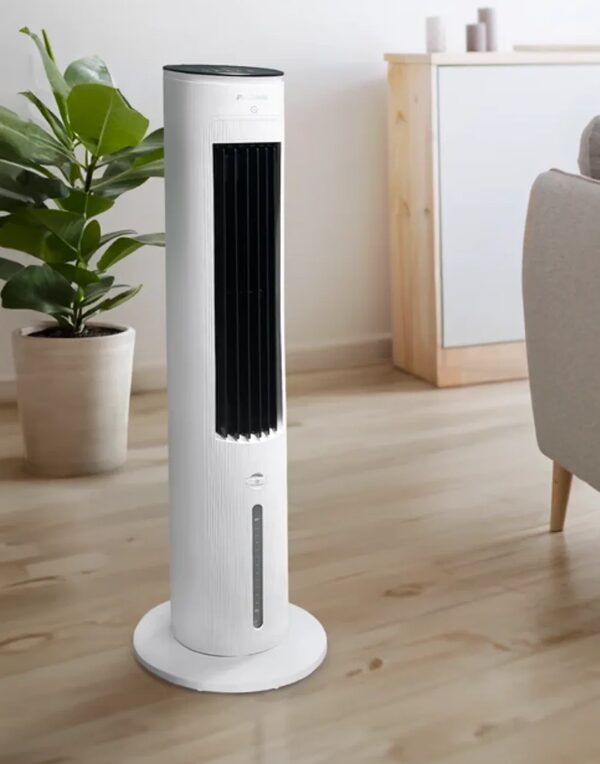 A white Pro Breeze tower fan standing on a wooden floor in a bright living room