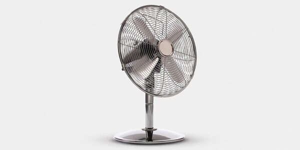 A chrome electric desk fan on a white background