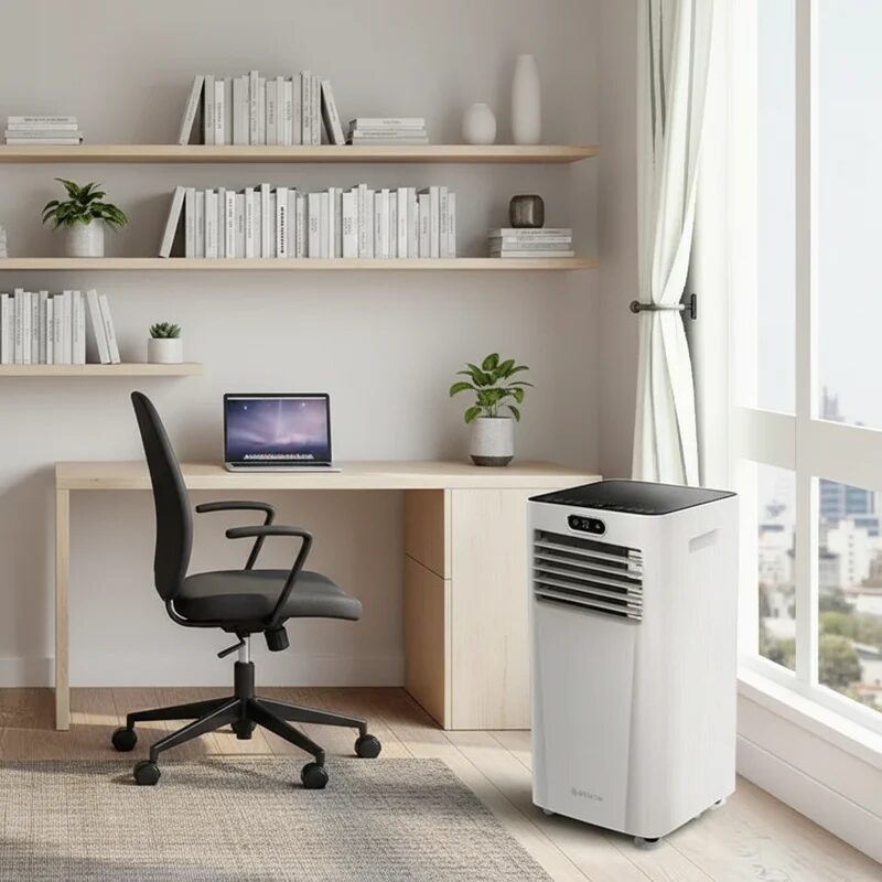 A white Meaco portable air conditioner standing in a home office beside a desk and window