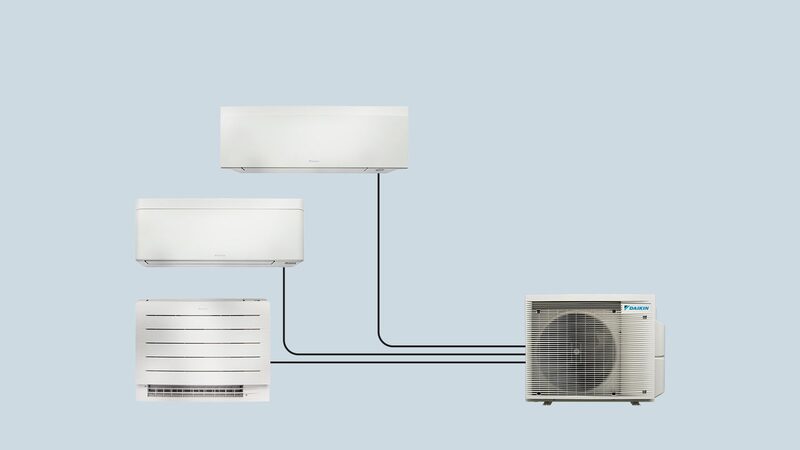 A Daikin multi-split air conditioning setup with one outdoor unit connected by lines to three indoor units on a plain blue background