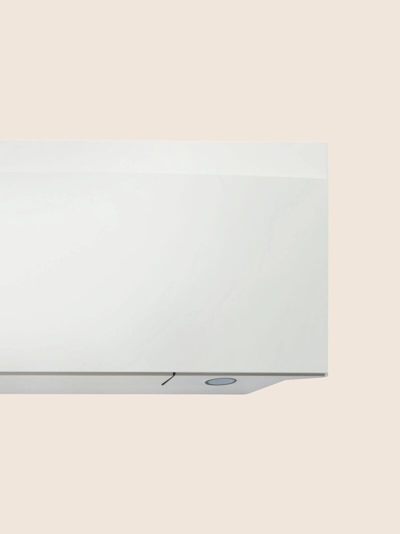 A close-up of a white wall-mounted air conditioning indoor unit against a plain background