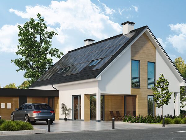 A modern house with solar panels on the roof and an electric car parked in the driveway
