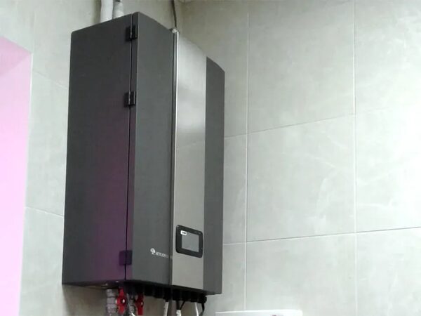 A Mycond wall-mounted ventilation unit with a digital control panel installed on a tiled wall in a house