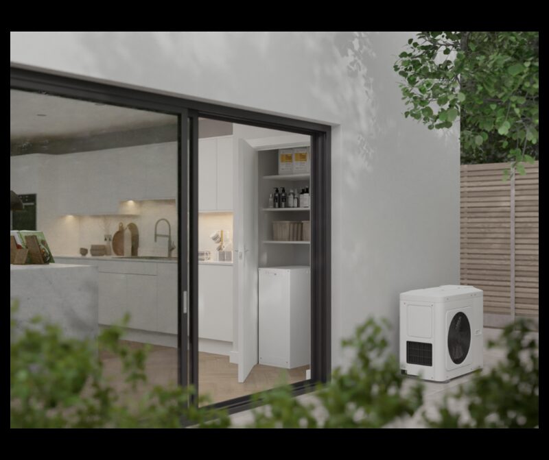 A Sunamp Thermino thermal battery heat storage unit installed in a utility cupboard beside a modern kitchen, seen through sliding glass doors