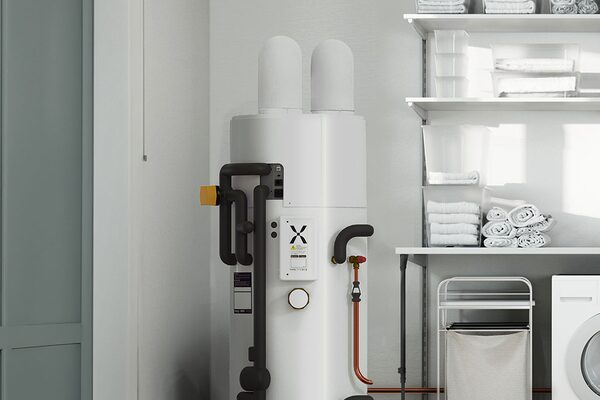 A Mixergy iHP X hot water cylinder installed in a utility room next to shelving and a washing machine