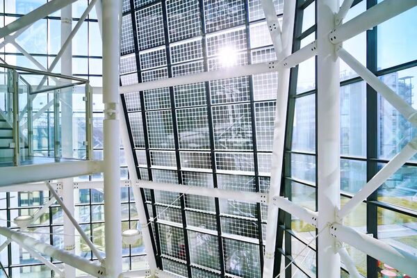 Semi-transparent solar panels forming a glazed atrium roof inside a modern building