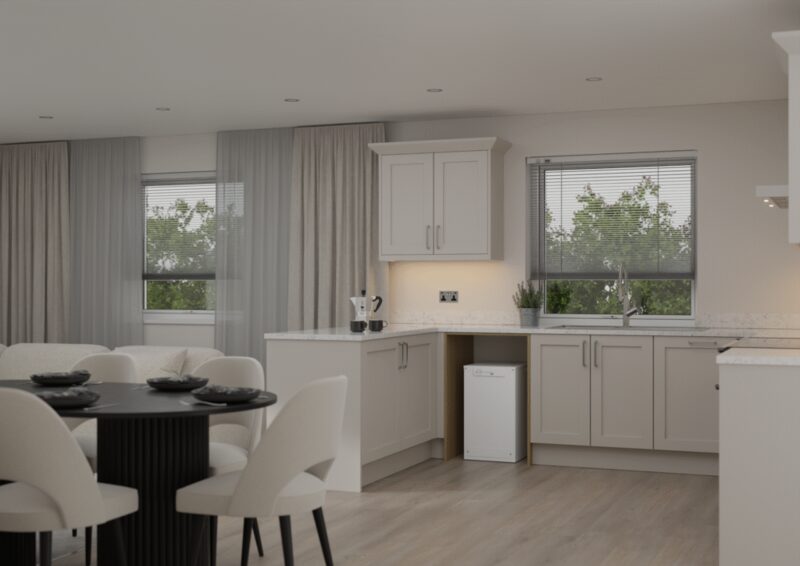 A white Sunamp compact heat battery unit installed in an open-plan kitchen under the worktop