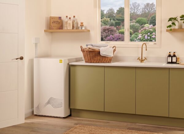 A tepeo ZEB heat battery boiler installed in a utility room next to green kitchen cabinets and a sink