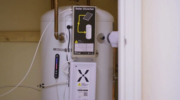A Mixergy hot water cylinder installed in a home with a Solar Diverter unit and X-branded controller attached