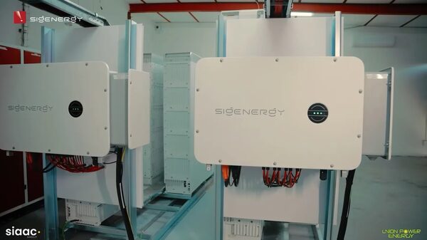 Sigenergy home battery storage units installed on racks in a utility room with visible cabling
