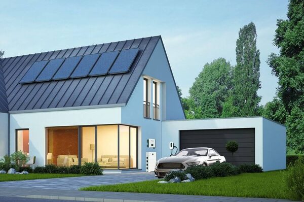 A modern house with rooftop solar panels, a wall-mounted battery and EV charger outside, and an electric car parked in the driveway