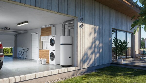 A white Daikin hot water cylinder installed in a modern garage utility room next to a stacked washer and dryer