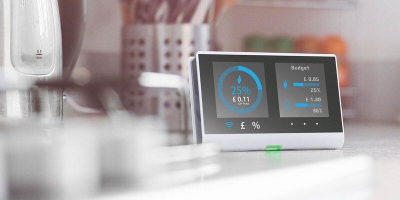 A smart meter energy display showing usage percentage and budget figures on a kitchen worktop