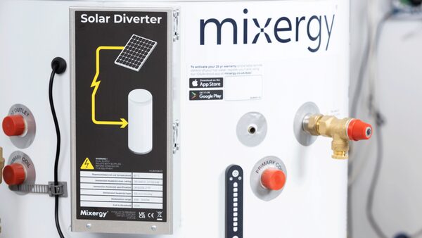 A Mixergy hot water cylinder with its Solar Diverter control panel mounted on the tank, showing a solar PV diagram and specification labels