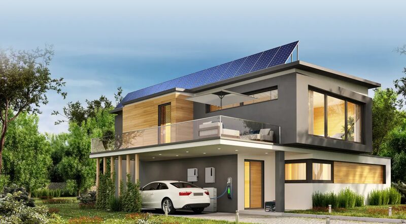 A modern two-storey house with rooftop solar panels, a wall-mounted battery and inverter, and an electric car charging in the driveway
