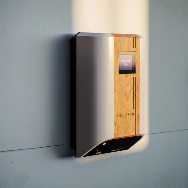 An Andersen wall-mounted electric vehicle charge point with a wood-finish front panel and small screen, mounted on a pale wall