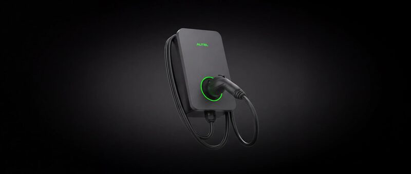 An Autel MaxiCharger wall-mounted EV charging unit with coiled cable and connector, lit by a green ring against a dark background