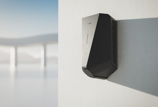 A black Easee electric car charger mounted on a white exterior wall