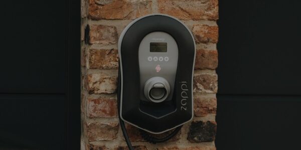A myenergi zappi EV charge point mounted on a brick wall