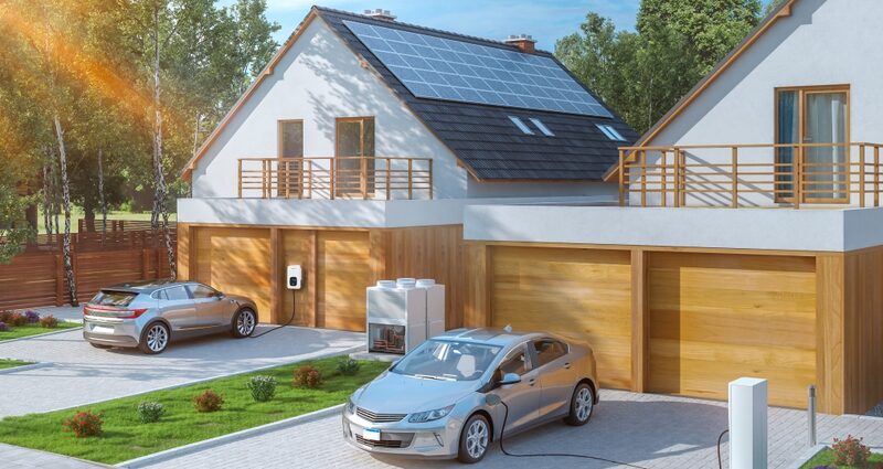 A 3D render of a modern house with rooftop solar panels, a wall-mounted EV charger charging a car in the driveway, and a battery/storage unit by the garage
