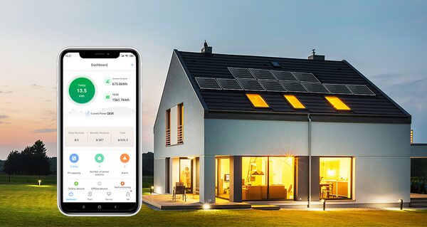 A modern house with rooftop solar panels at dusk beside a smartphone showing a Growatt energy monitoring dashboard app